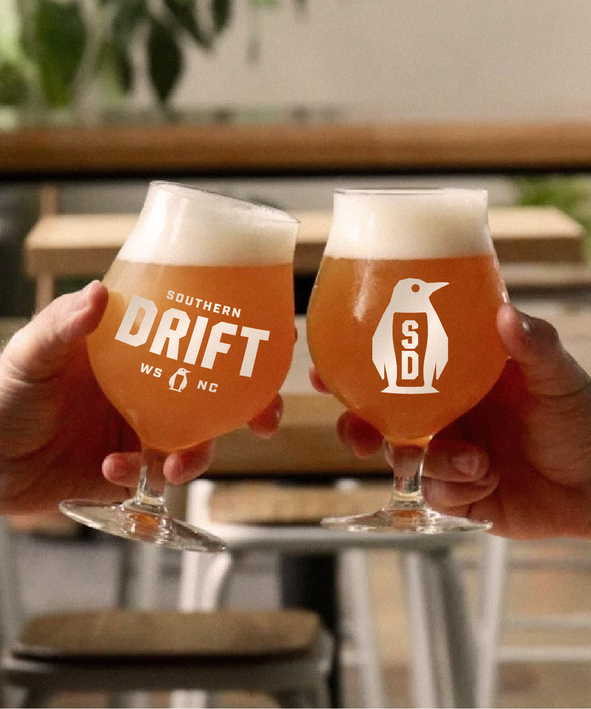 Branded glassware featuring Southern Drift Brewing Co's alternate marks